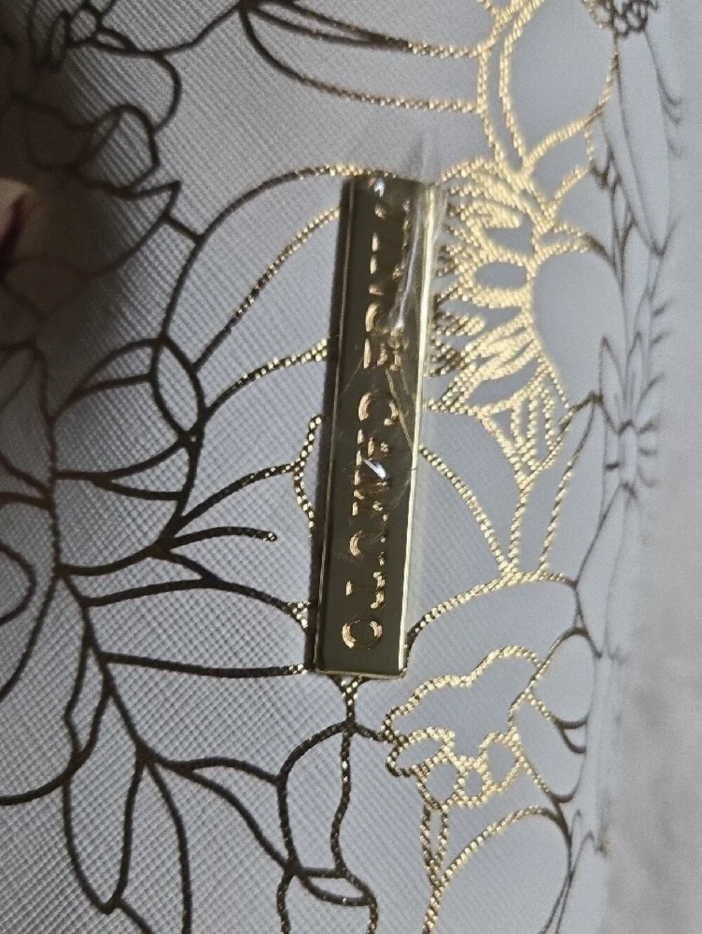 Vince Camuto White Cosmetic Bag with Gold Floral Accents